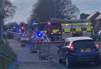 Homes could be evacuated as busy road closed after gas main struck